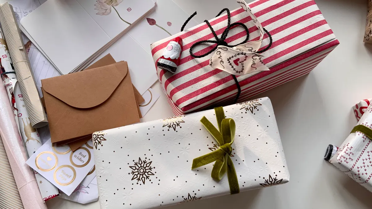 Gift wrapping tools and accessories — The Complete Guide Wrapped presents with tags, ribbon, scissors, and wrapping paper tools