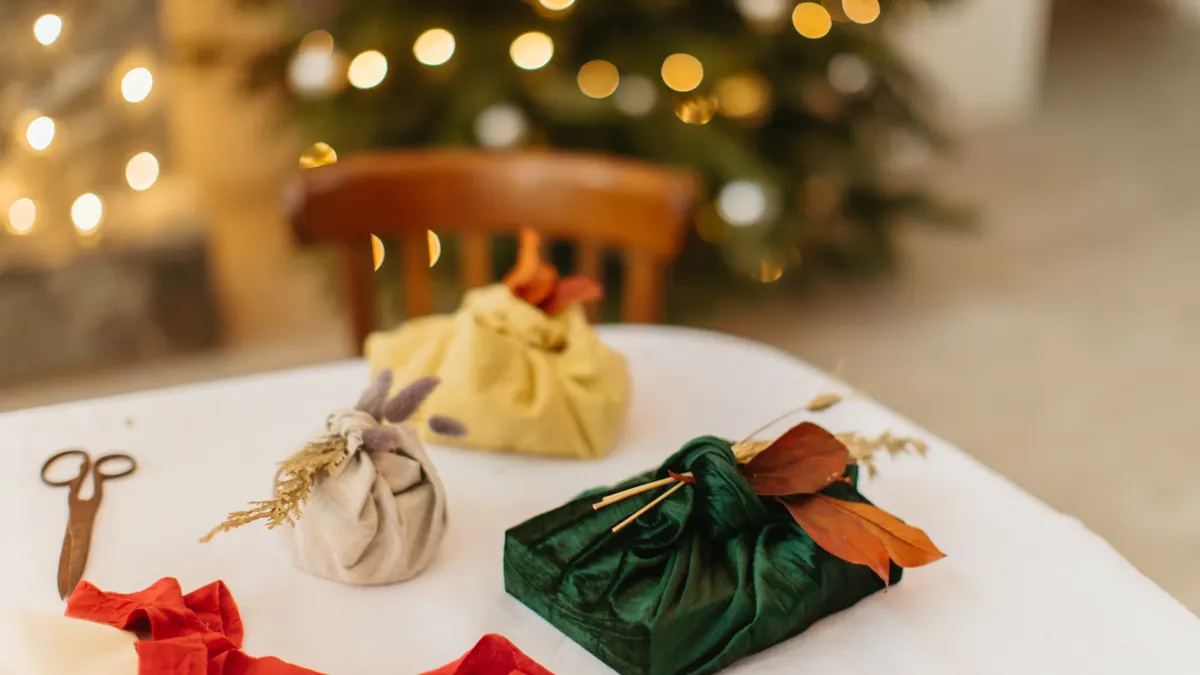 How to wrap a gift in fabric Several fabric-wrapped gifts on a table